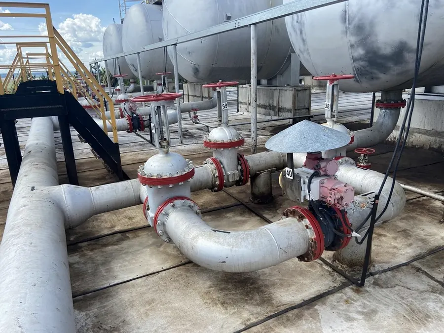 Pipework and valves on a petrochemical site standing on a continuous lined surface
